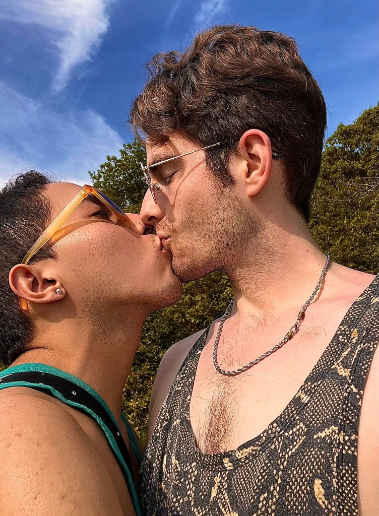 August afternoon on the bank Couple kissing under a bright blue August sky at Rock River in Newfane, Vermont — LGBTQ-welcoming swimming hole in Windham County