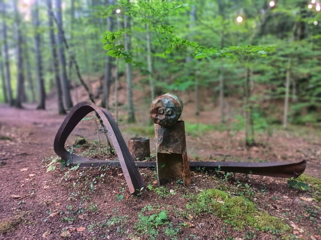Forest trail sculpture Weathered metal trail sculpture on the mossy forest floor along the Rock River walk-in route, Newfane Vermont